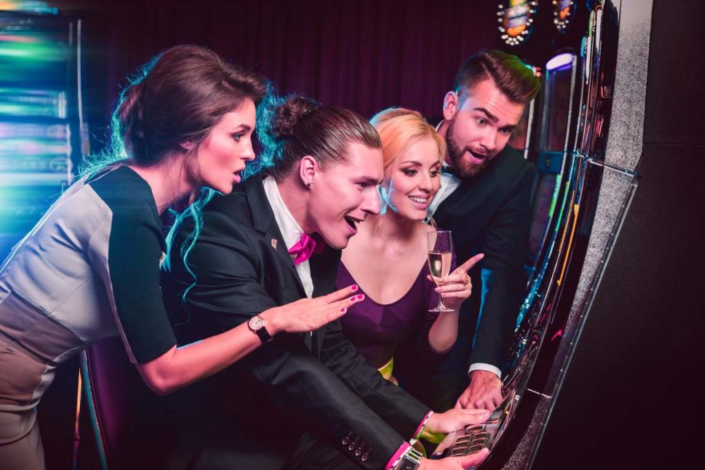Group of friends playing slot machine
