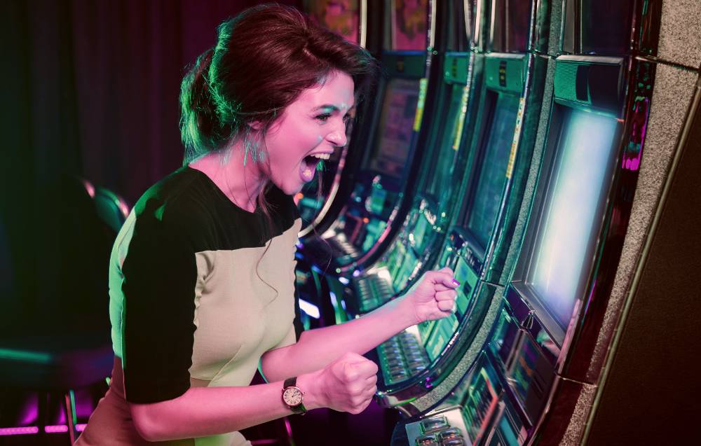 A happy woman won pokie game at slot machine
